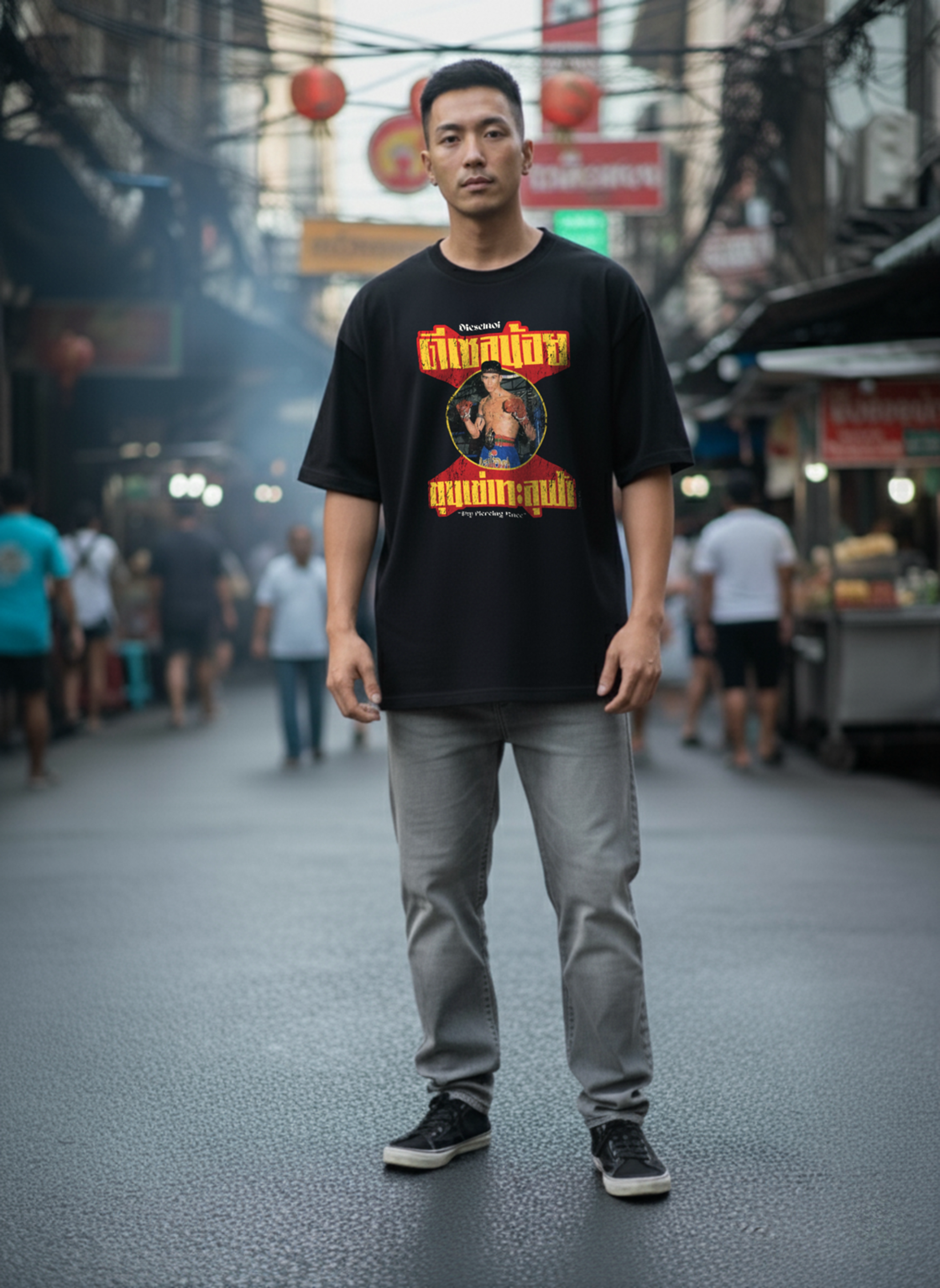 Man wearing a black t-shirt with graphic design on a street in an urban setting